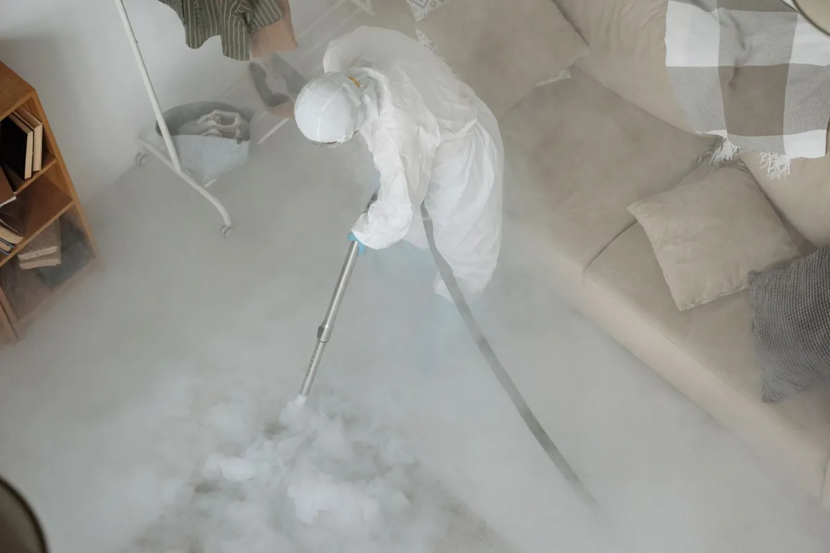 Biohazard cleanup technician in protective equipment, Stowell, TX